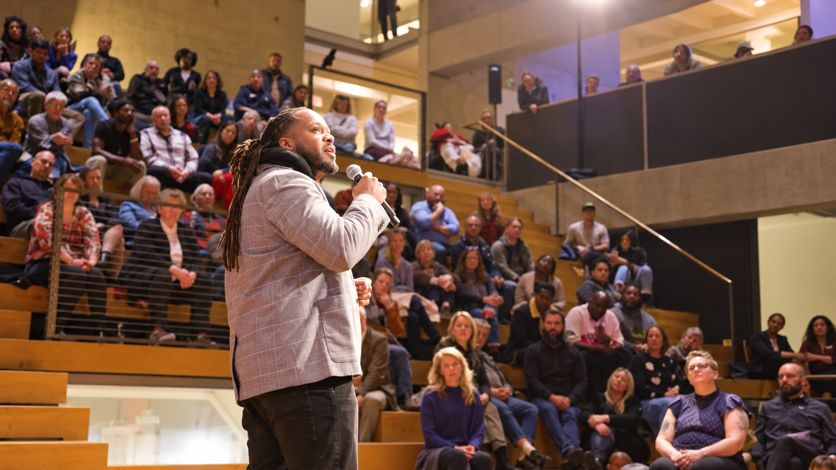 Alex Green speaking with a microphone at TEDxPortland
